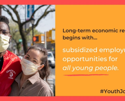 Two young people of color masked together, outside, in a city. We need employment opportunities for all young people.